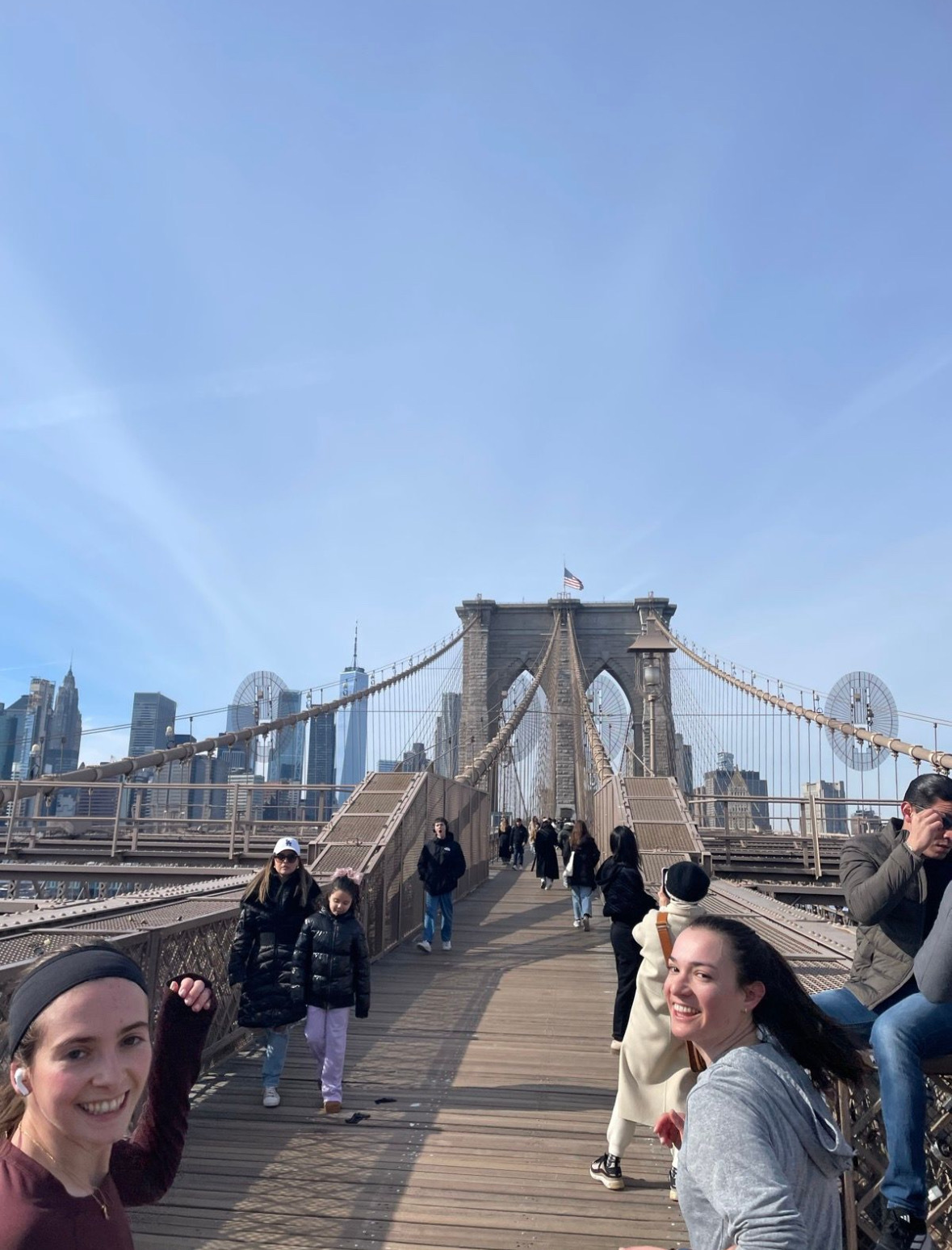 Rosie on the Brooklyn Bridge with the Manhattan skyline behind her.